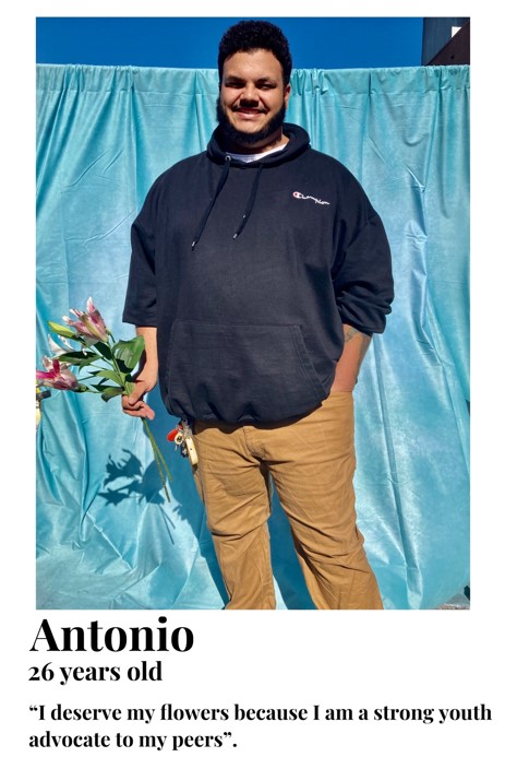 Antionio holding flowers, I deserve flowers because I am a strong youth advocate to my peers.