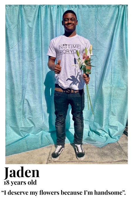 Jaden holding flowers giving us a thumbs up. I deserve my flowers because I'm handsome.